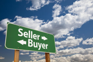 Seller, Buyer Green Road Sign Over Dramatic Clouds and Sky.