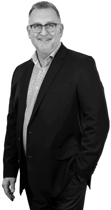 Professional portrait of Dale Bryant, a realtor, dressed in a business suit with a confident smile, presented in black and white for a timeless look.