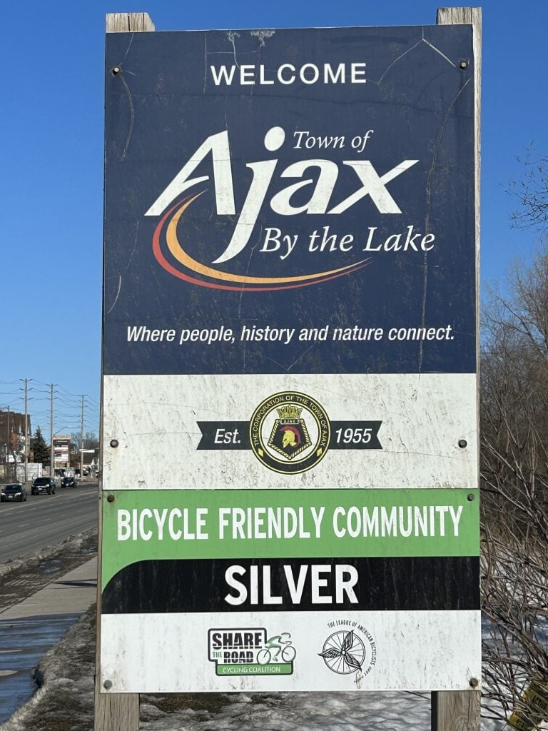 Ajax Sign, highlighted by its clean, modern design with bold lettering on a structured, metallic background, welcoming visitors to Ajax, Ontario.