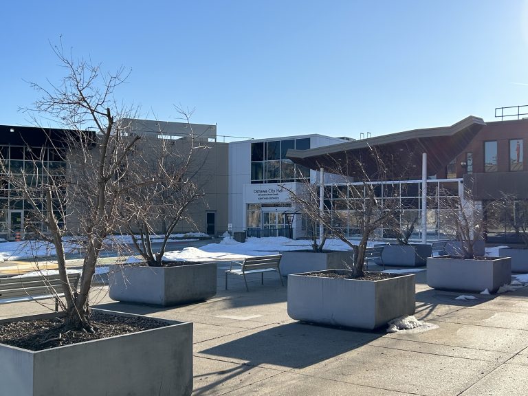 Oshawa City Hall, presenting a mixture of traditional and modern architectural styles with its impressive facade and large windows, serving as a hub for civic administration in Oshawa.