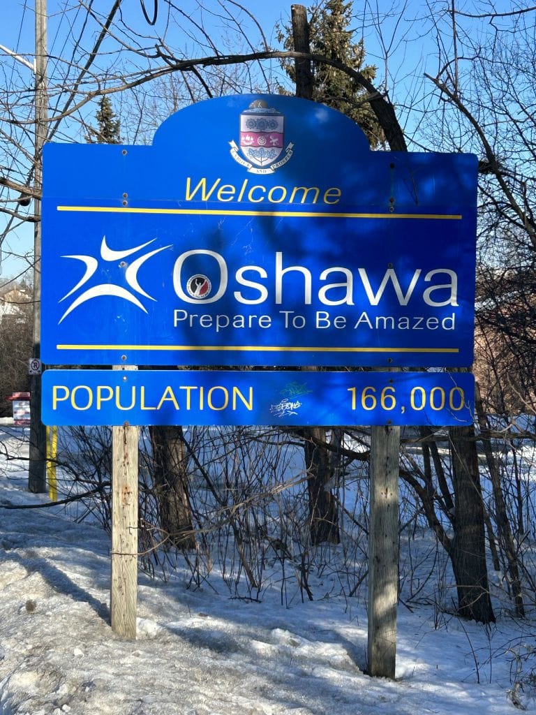 Oshawa Sign, featuring modern and bold lettering on a dark background, prominently displayed at the city's entrance, inviting visitors and residents to Oshawa, Ontario.
